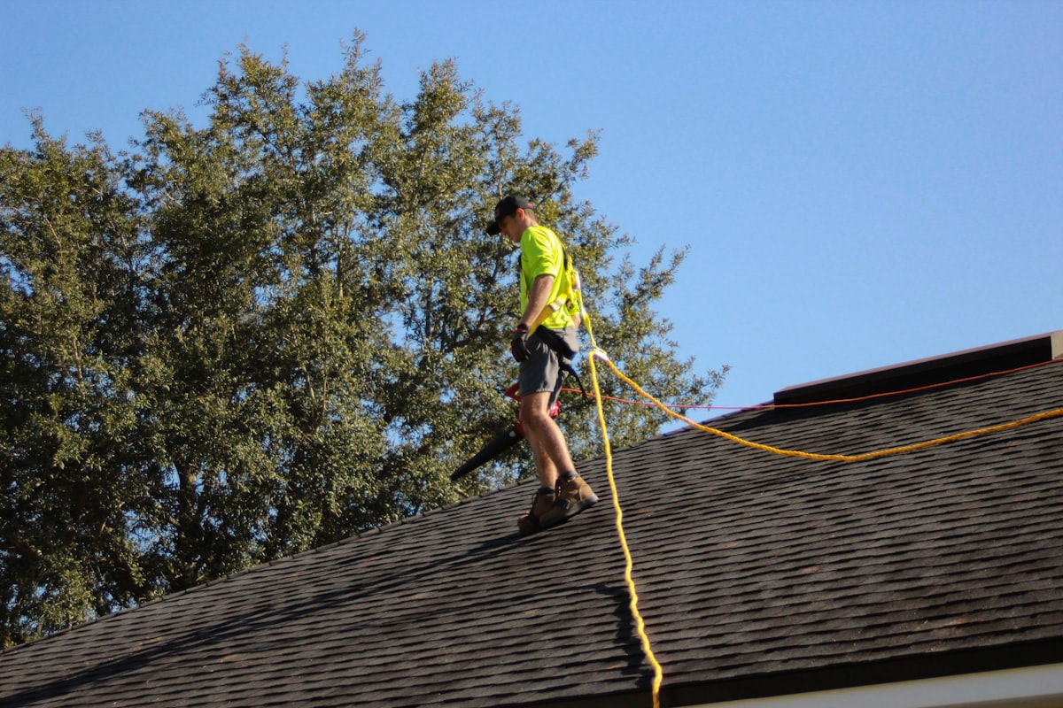 Roofer walking a newly shingled roof