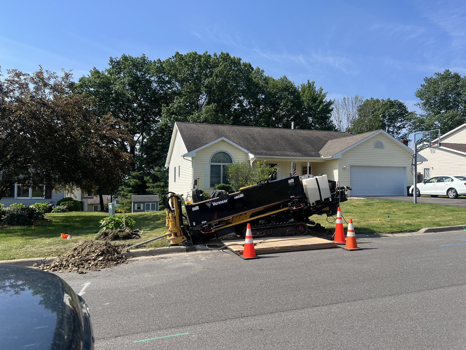 Directional drill rig boring beneath a roadway crossing