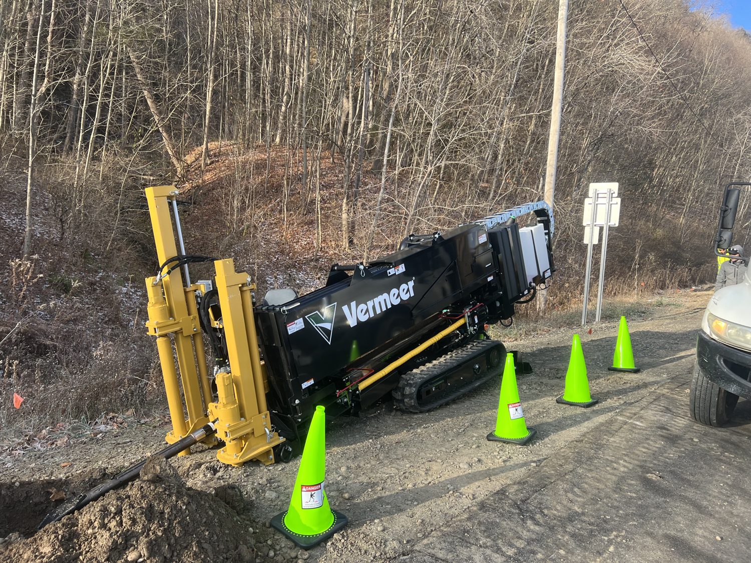 Directional drill rig staged at a bore entry pit on a utility jobsite
