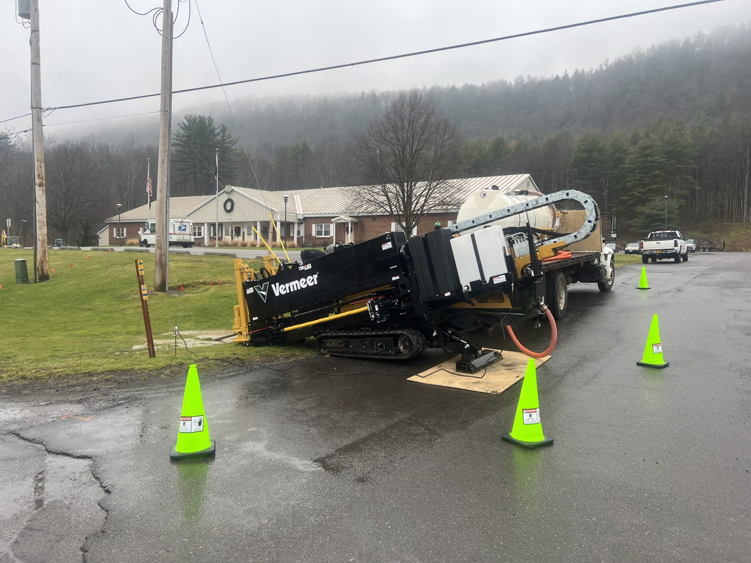 Drilling crew running pipe on a horizontal directional bore