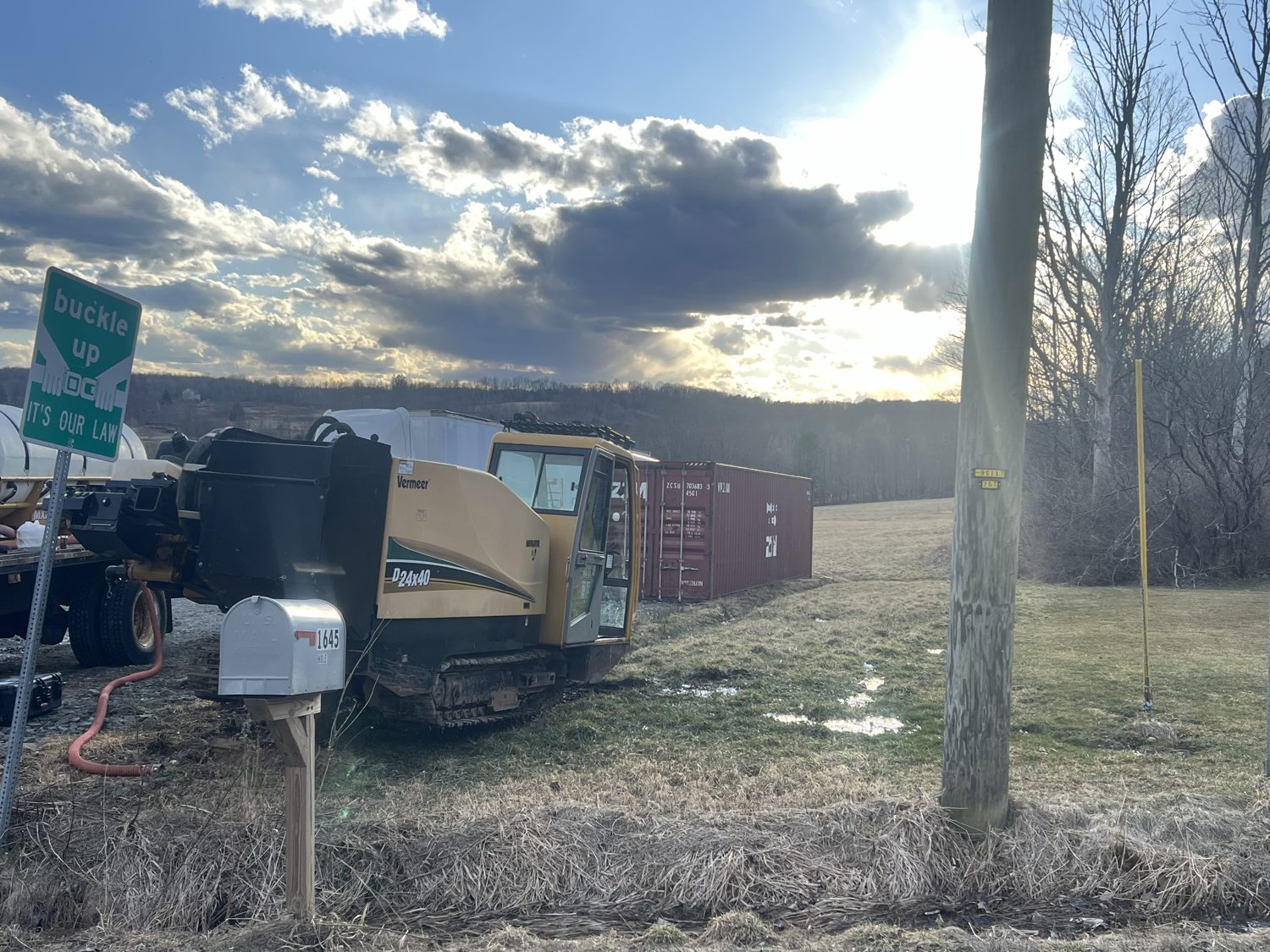 HDD rig set up for a crossing with conduit staged nearby
